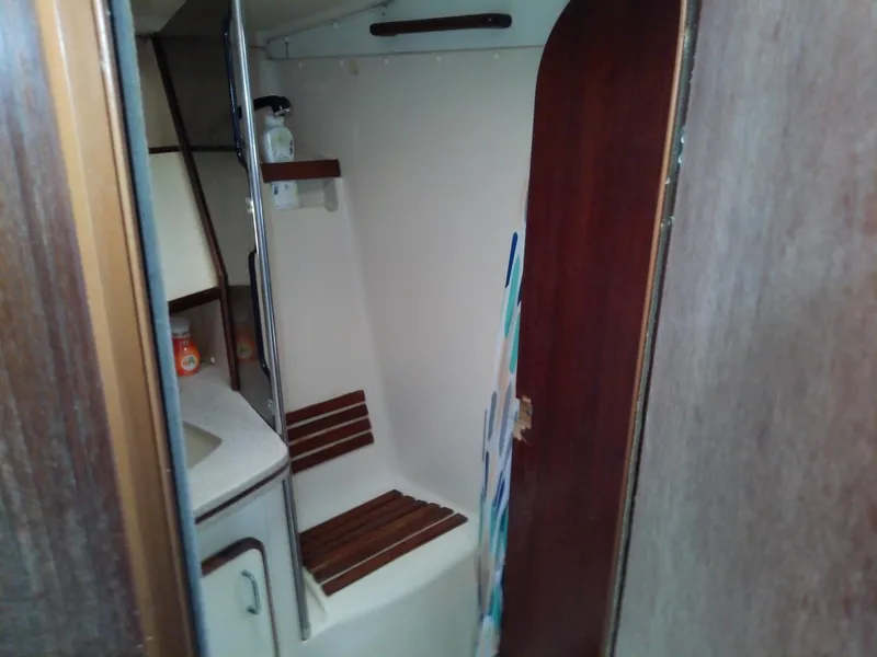 Slide: The Image of Interior of 1990 Hunter Passage 42 sailboat bathroom with wooden accents and shower area. - 34