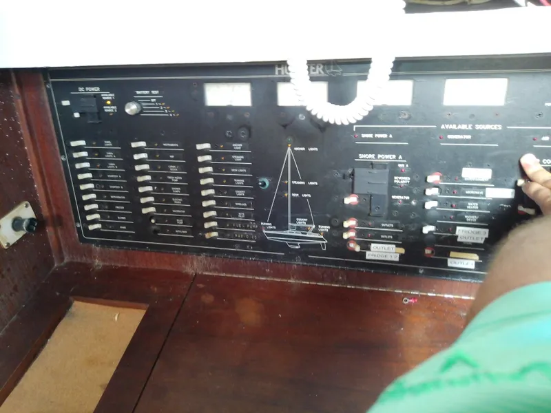 Slide: The Image of Control panel of a 1990 Hunter Passage 42 sailboat with switches and labels. - 35