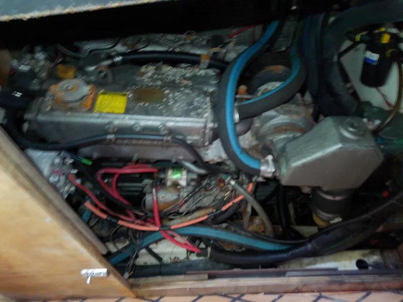 Slide: The Image of Engine compartment of a 1990 Hunter Passage 42 sailboat, showing various hoses and components. - 37