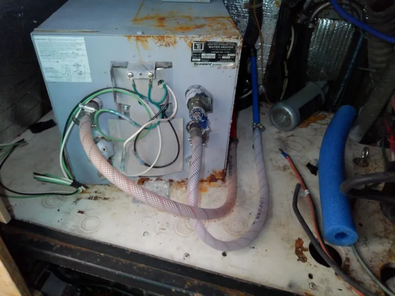 Slide: The Image of Rusty water heater in a 1990 Hunter Passage 42 boat engine compartment. - 38