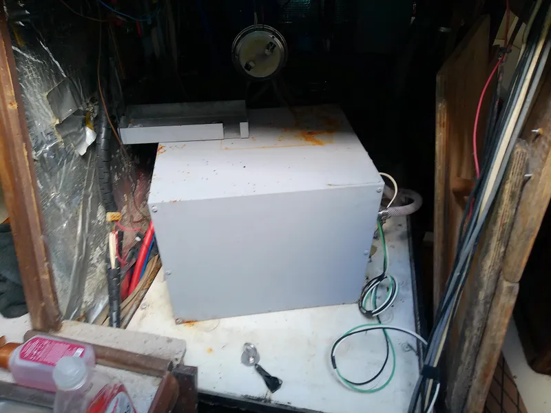 Slide: The Image of Engine compartment of a 1990 Hunter Passage 42 sailboat, showing mechanical components and wiring. - 40