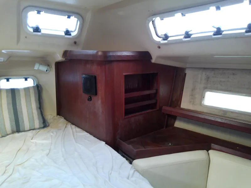 Slide: The Image of Interior cabin of 1990 Hunter Passage 42 sailboat with wood paneling and bedding. - 43