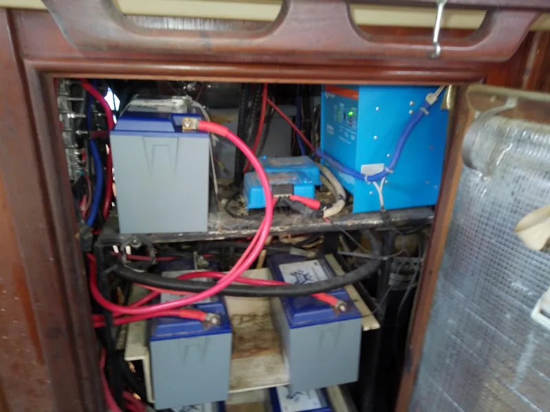Slide: The Image of Battery compartment of a 1990 Hunter Passage 42 sailboat with wiring and equipment. - 48