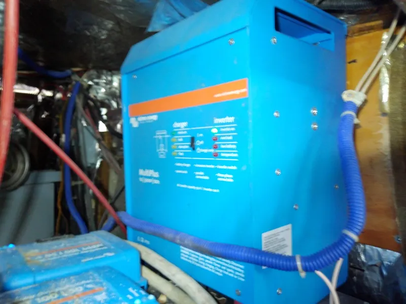 Slide: The Image of Electrical system inside a 1990 Hunter Passage 42 sailboat, featuring a blue inverter. - 49