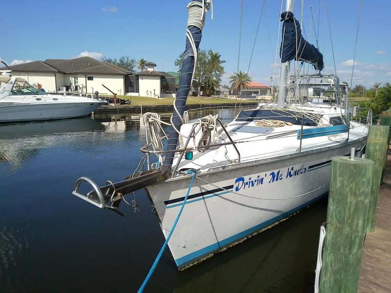 Slide: The Image of Hunter Passage 42 sailboat, 1990 model, docked in a marina with clear skies. - 5