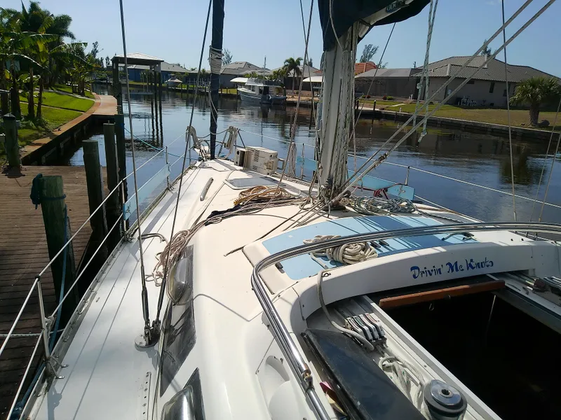 Slide: The Image of Hunter Passage 42 sailboat docked in a serene canal, 1990 model. - 7