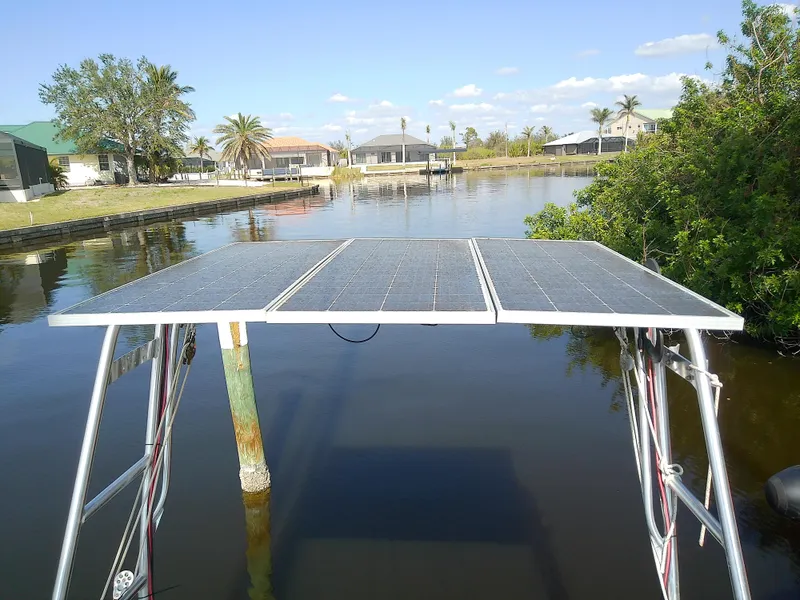 Slide: The Image of Solar panels on a 1990 Hunter Passage 42 yacht, docked by a scenic waterfront. - 8