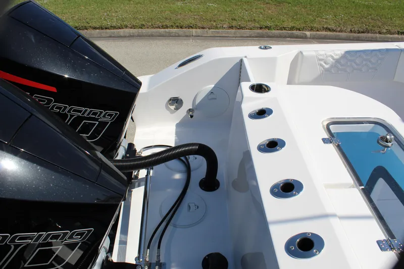 Slide: The Image of 2024 Fountain 32 NX boat with dual racing engines and rod holders, showcasing sleek design. - 26