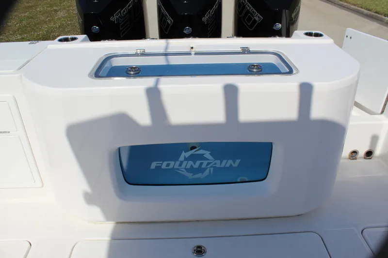 Slide: The Image of 2024 Fountain 32 NX boat with livewell and triple outboard engines. - 29