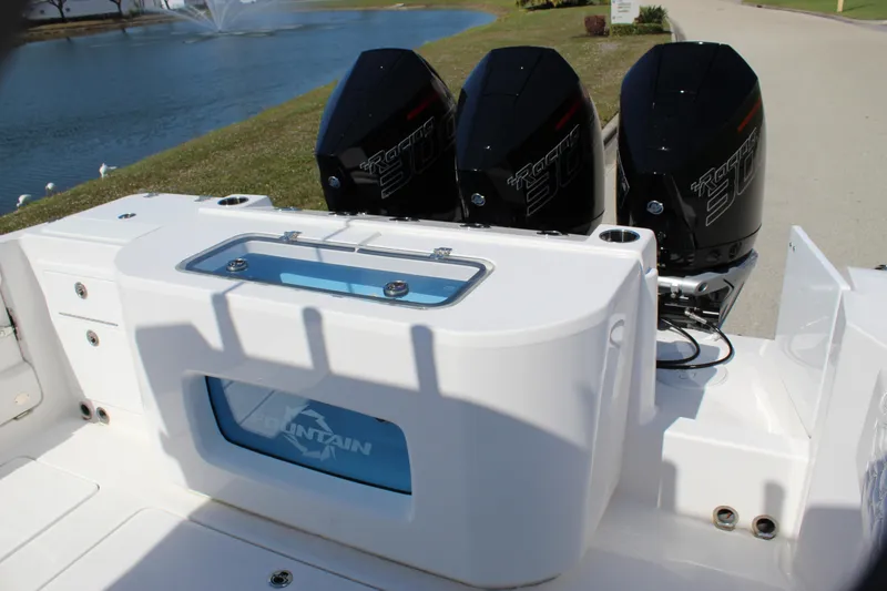 Slide: The Image of 2024 Fountain 32 NX boat with triple outboard engines, rear view. - 30