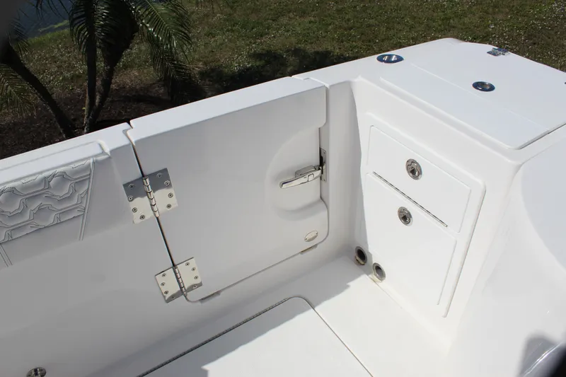 Slide: The Image of 2024 Fountain 32 NX boat interior, featuring white storage compartments and sleek design elements. - 33