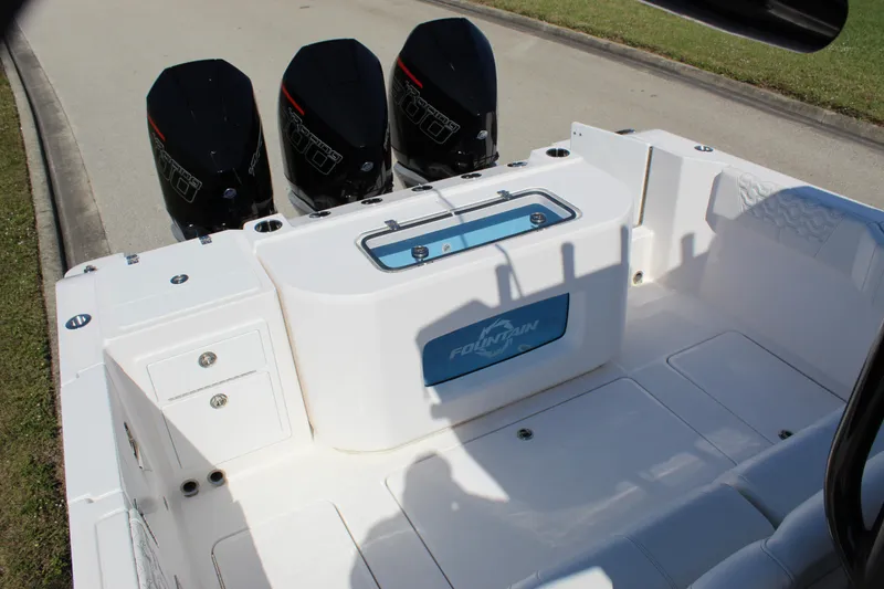 Slide: The Image of 2024 Fountain 32 NX boat with triple outboard engines, spacious deck, and storage compartments. - 36