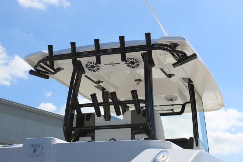 Slide: The Image of 2024 Fountain 32 NX boat with T-top and rod holders against a clear blue sky. - 39
