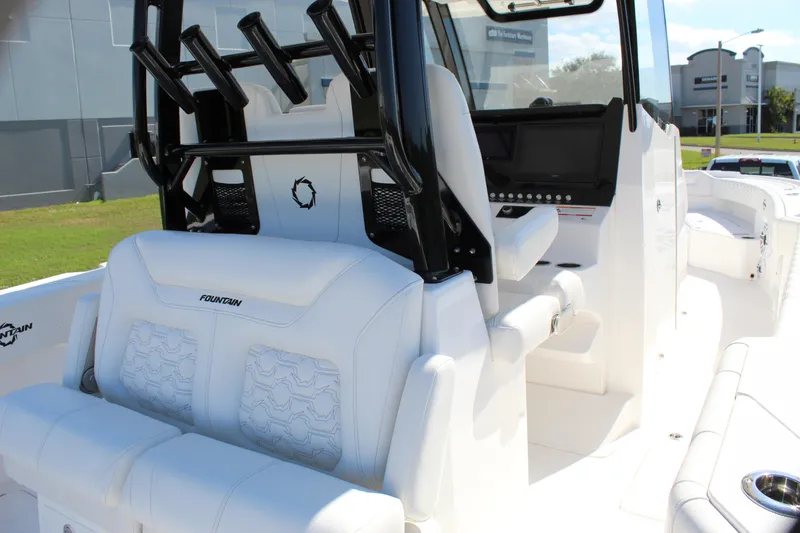 Slide: The Image of 2024 Fountain 32 NX boat interior with white seating and black rod holders. - 44