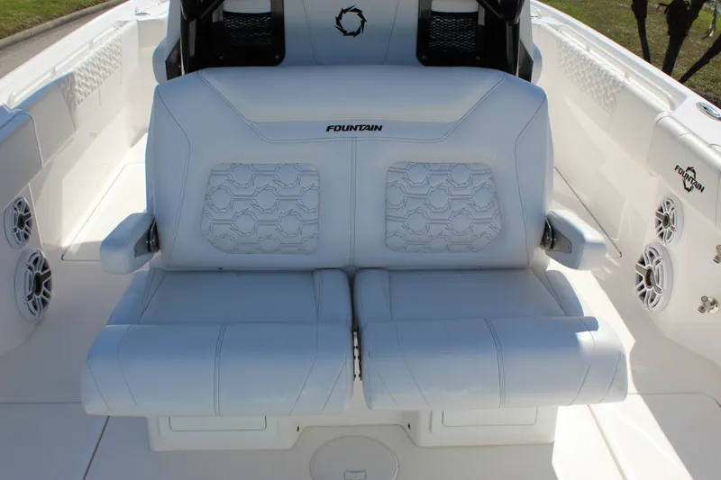 Slide: The Image of 2024 Fountain 32 NX boat interior with white cushioned seating and speaker system. - 46