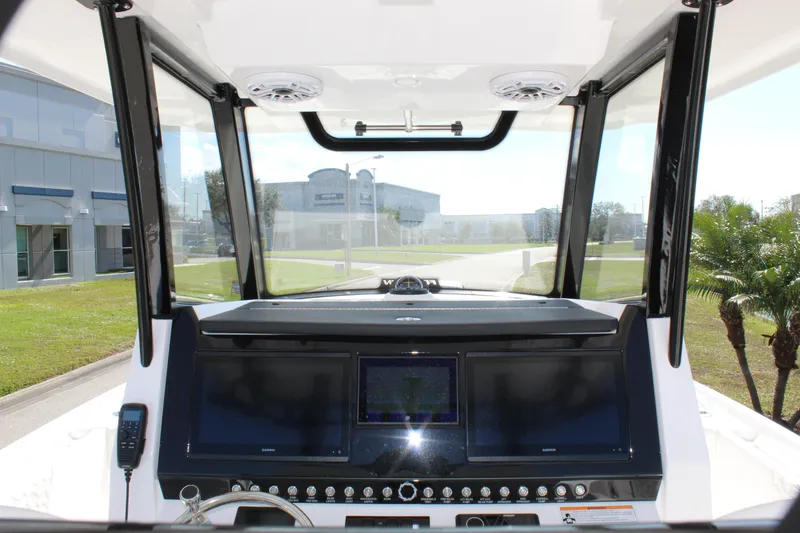 Slide: The Image of 2024 Fountain 32 NX boat dashboard with modern navigation screens and controls. - 48