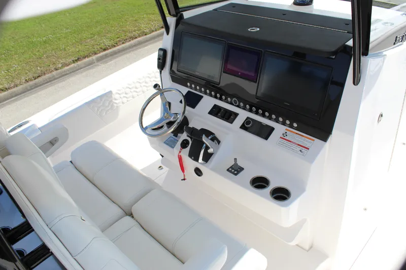 Slide: The Image of 2024 Fountain 32 NX boat cockpit with modern controls and comfortable seating. - 52