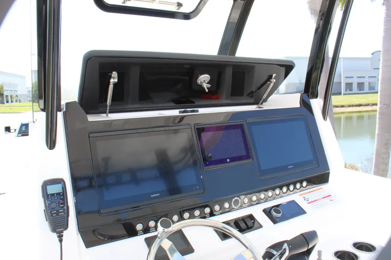 Slide: The Image of 2024 Fountain 32 NX boat dashboard with dual screens and control panel. - 54