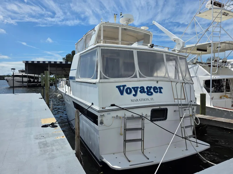 Slide: The Image of 1990 Californian 45 Motor Yacht docked, named "Voyager," with clear skies and marina backdrop. - 15