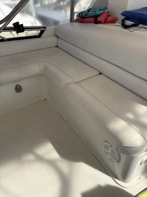 Slide: The Image of 1990 Californian 45 Motor Yacht interior with white seating and nautical accessories. - 23