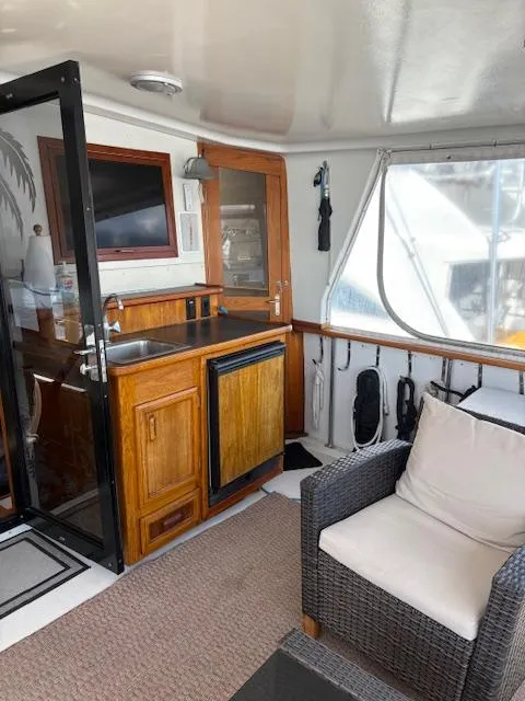 Slide: The Image of 1990 Californian 45 Motor Yacht interior with kitchenette and seating area. - 26