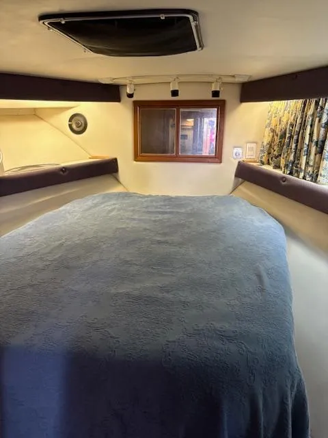 Slide: The Image of 1990 Californian 45 Motor Yacht interior cabin with bed and window. - 45