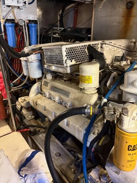 Slide: The Image of Engine room of a 1990 Californian 45 Motor Yacht with visible components and filters. - 50
