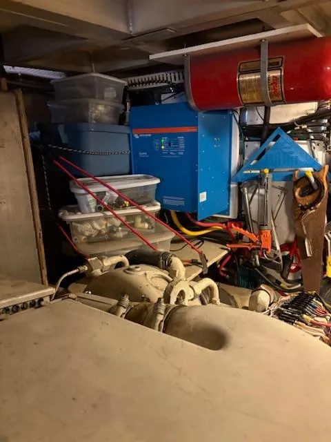 Slide: The Image of Engine room of 1990 Californian 45 Motor Yacht with equipment and storage containers. - 51