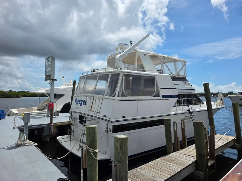 Slide: The Image of 1990 Californian 45 Motor Yacht docked under cloudy sky, featuring spacious deck and classic design. - 8
