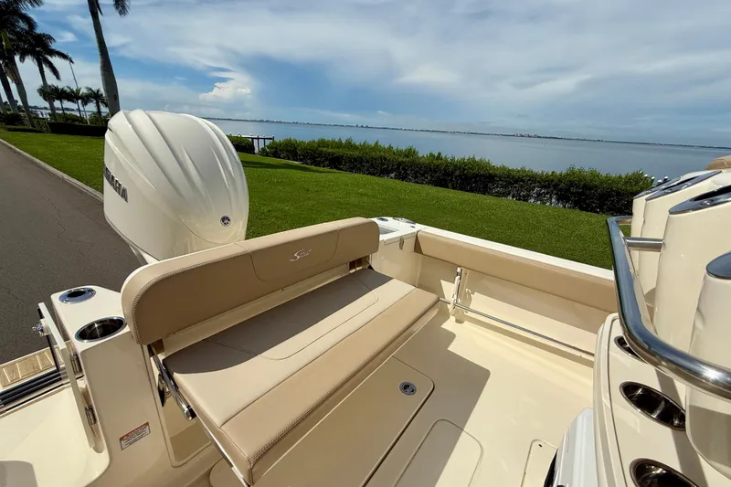 Slide: The Image of 2025 Scout 240 XSF boat with Yamaha engine, scenic waterfront view. - 9