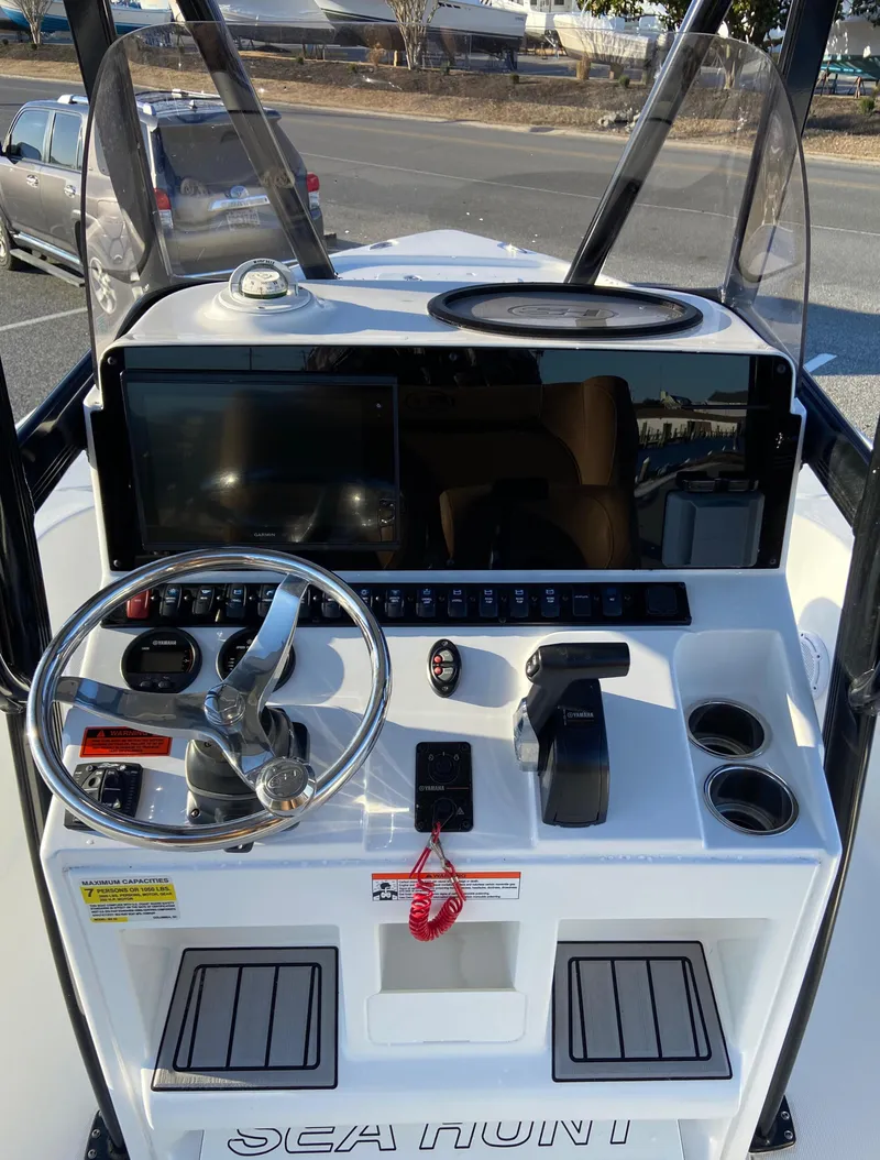 Slide: The Image of 2021 Sea Hunt BX 22 BR boat console with steering wheel and controls. - 11