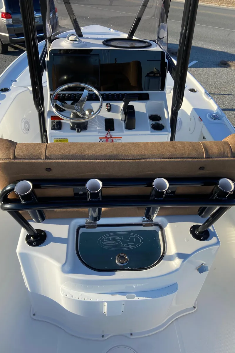 Slide: The Image of 2021 Sea Hunt BX 22 BR boat cockpit with steering wheel and rod holders. - 12