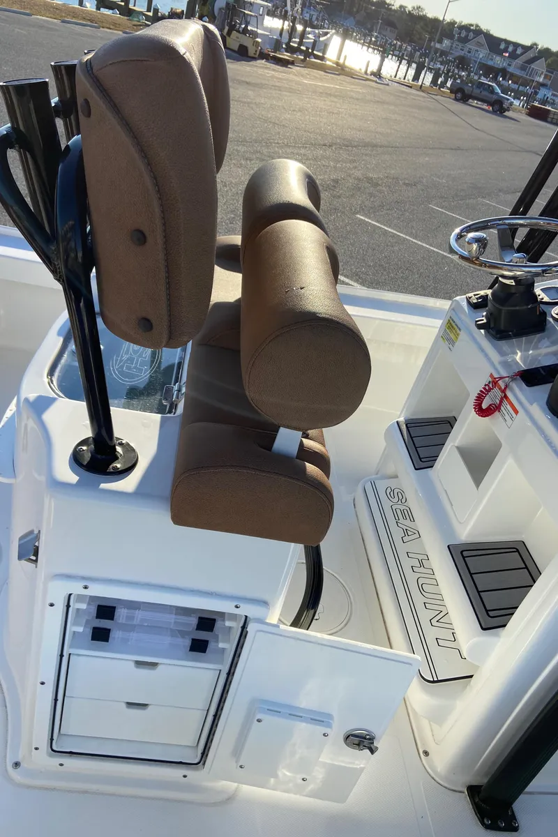 Slide: The Image of 2021 Sea Hunt BX 22 BR boat interior with brown seating and control panel. - 13