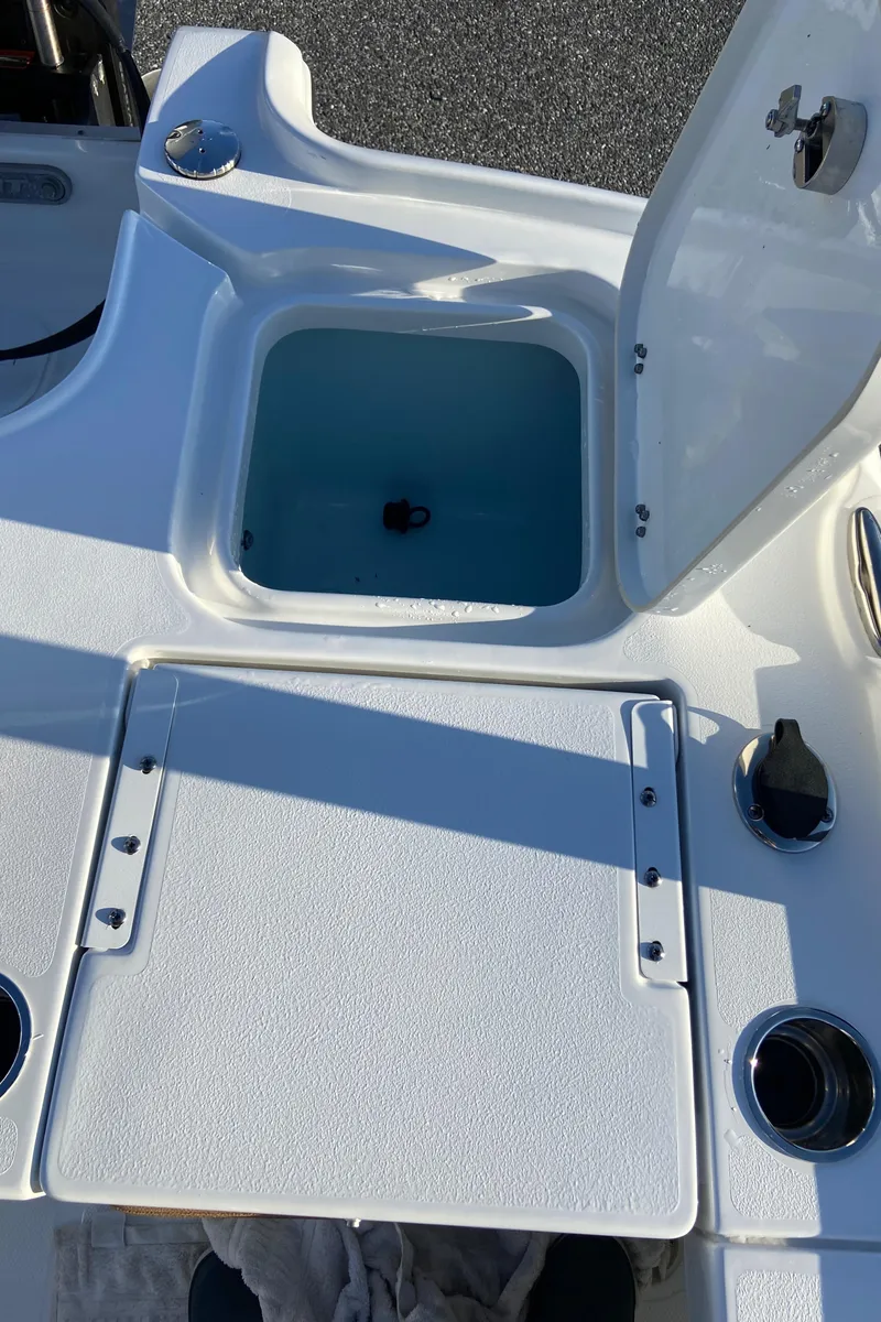 Slide: The Image of 2021 Sea Hunt BX 22 BR boat with open storage compartment. - 18
