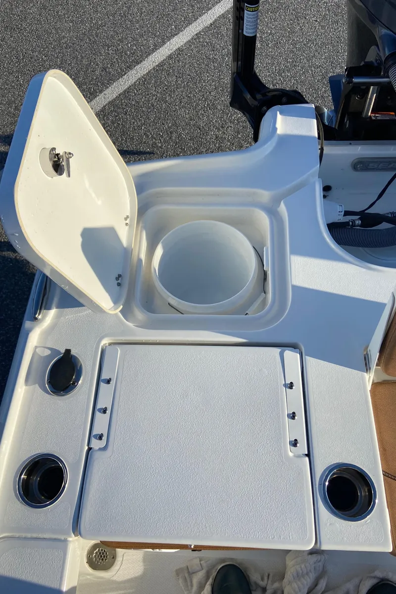 Slide: The Image of 2021 Sea Hunt BX 22 BR boat deck with storage compartment and cup holders. - 19