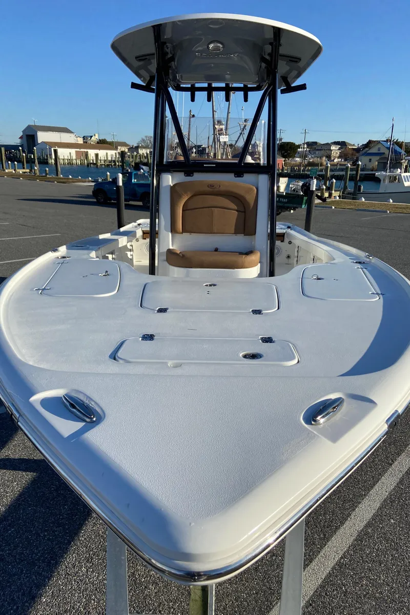 Slide: The Image of 2021 Sea Hunt BX 22 BR boat, docked, with spacious deck and T-top. - 3