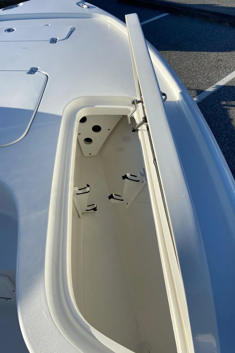Slide: The Image of 2021 Sea Hunt BX 22 BR boat storage compartment open, showcasing interior space. - 8
