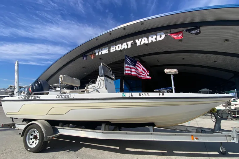 Slide: The Image of 2005 Skeeter ZX20 Bay boat with Yamaha outboard motor in a marina setting. - 11