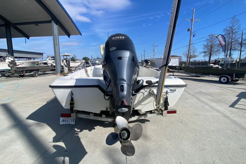 Slide: The Image of 2005 Skeeter ZX20 Bay boat with console and seating in a marina setting. - 14