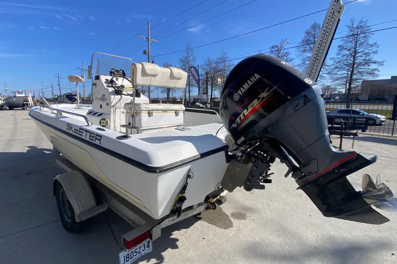 Slide: The Image of 2005 Skeeter ZX20 Bay boat deck in a marina, clear sky background. - 15