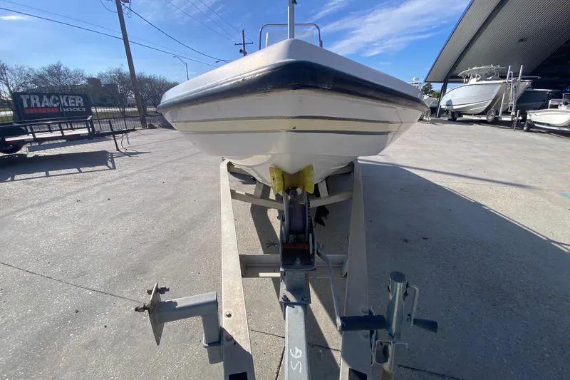 Slide: The Image of 2005 Skeeter ZX20 Bay boat in a marina, showcasing spacious deck and console. - 18