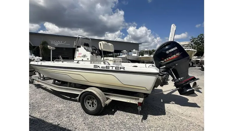 Slide: The Image of 2005 Skeeter ZX20 Bay boat on trailer, displayed outdoors with American flag. - 9