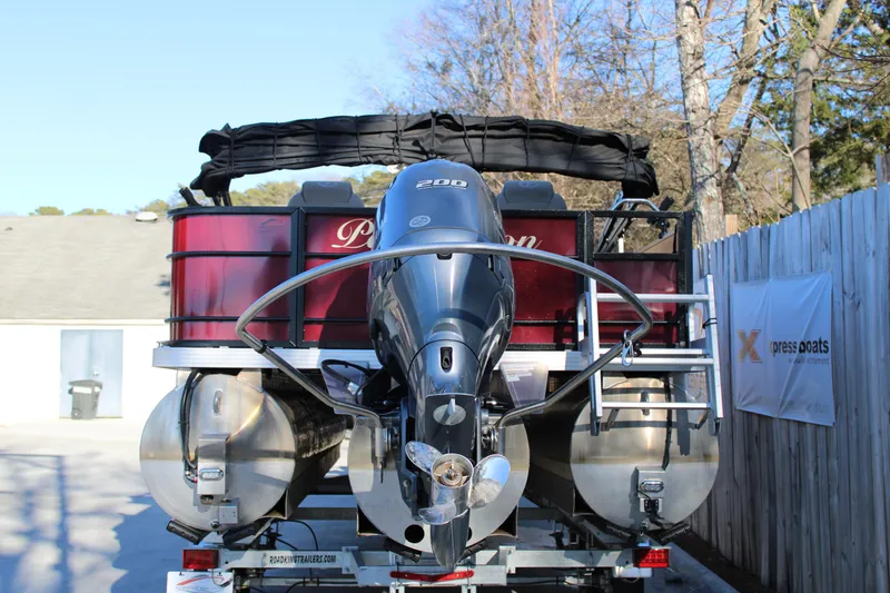Slide: The Image of 2022 Veranda VR22F2 Luxury pontoon boat with powerful outboard motor, parked outdoors. - 16