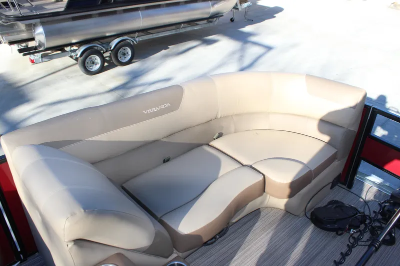 Slide: The Image of 2022 Veranda VR22F2 Luxury boat with beige seating and trailer in background. - 5