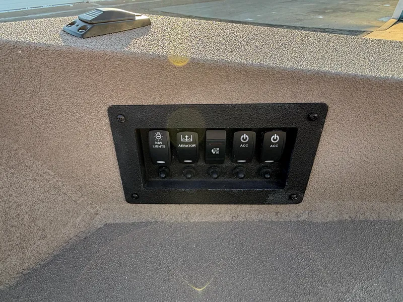 Slide: The Image of Control panel on 2025 Excel 1651 River Warrior boat, featuring multiple switches. - 18