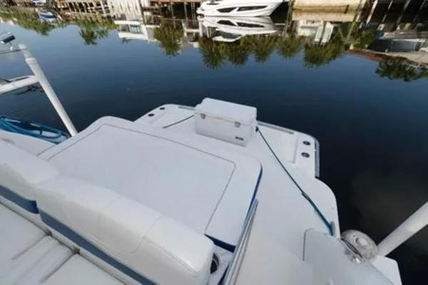 Slide: The Image of 2017 Formula 37 PC boat deck with seating and cooler, docked by calm water. - 13