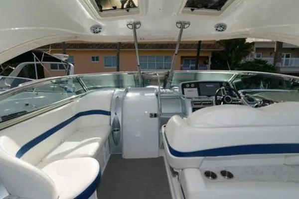 Slide: The Image of 2017 Formula 37 PC yacht interior with white and blue seating, modern dashboard, and open sunroof. - 17