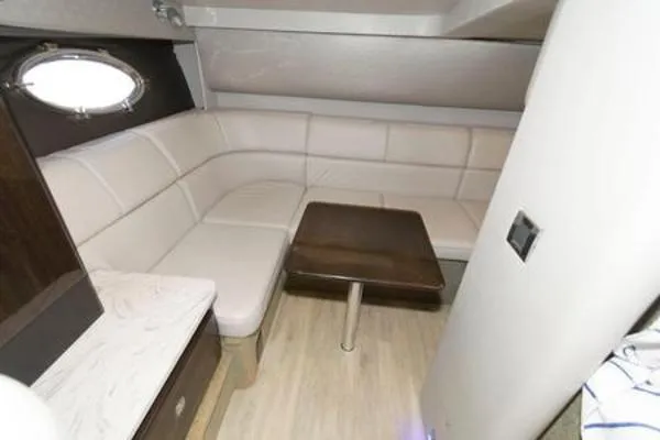 Slide: The Image of 2017 Formula 37 PC yacht interior with beige seating and wooden table. - 24