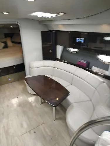 Slide: The Image of 2017 Formula 37 PC yacht interior with curved seating and wooden table. - 26