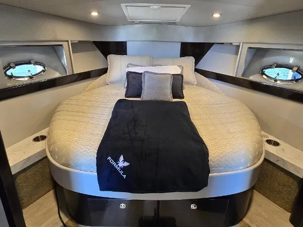 Slide: The Image of Luxurious 2017 Formula 37 PC yacht cabin with plush bedding and modern design. - 29